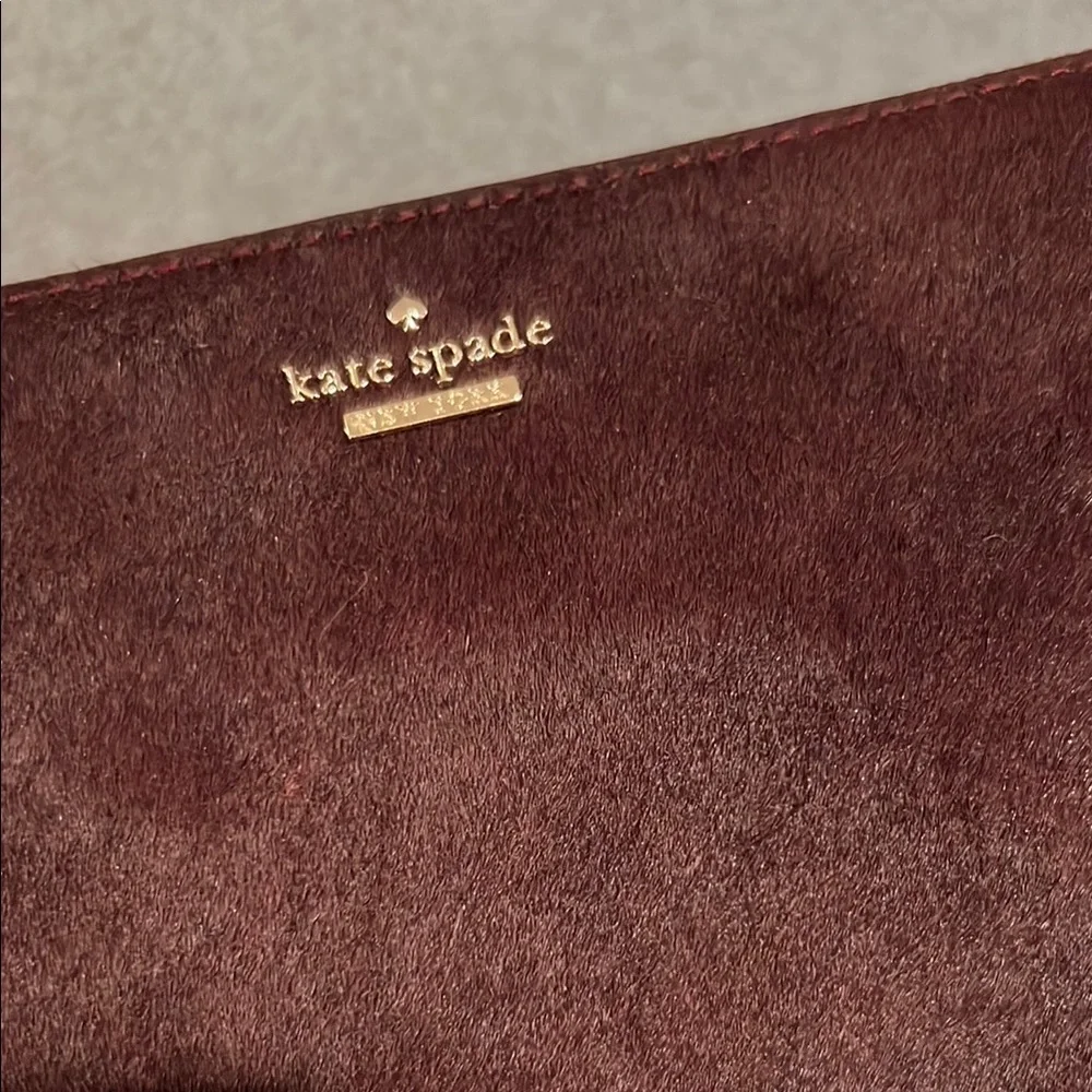 NWT kate spade burgundy suede pouch with gold logo